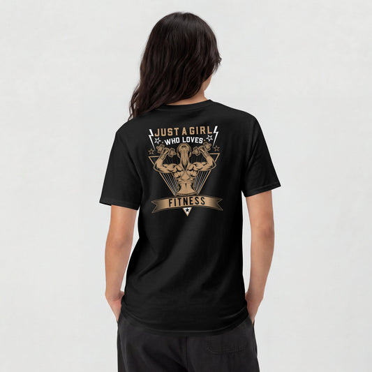 A woman shown from the back wearing a black t-shirt with a large tan graphic on the back that reads 'JUST A GIRL WHO LOVES FITNESS' around an illustrated muscular figure.