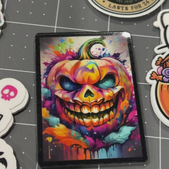 Video of spooky Halloween stickers and cute kid friendly stickers. Pumpkins, Hello Kitty, and jack-o-lanterns. 